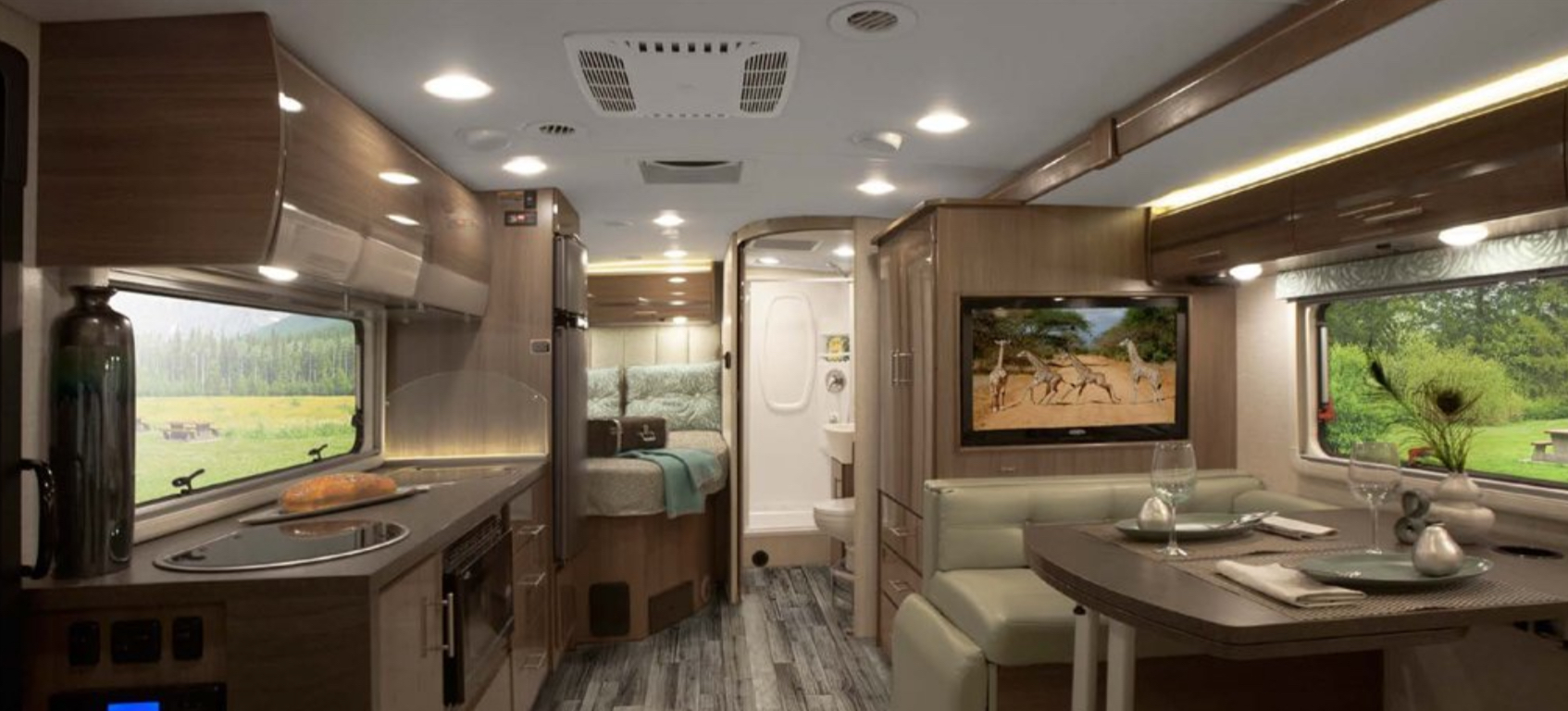 Motorcoach interior with seating and a table for discussing the shoot.